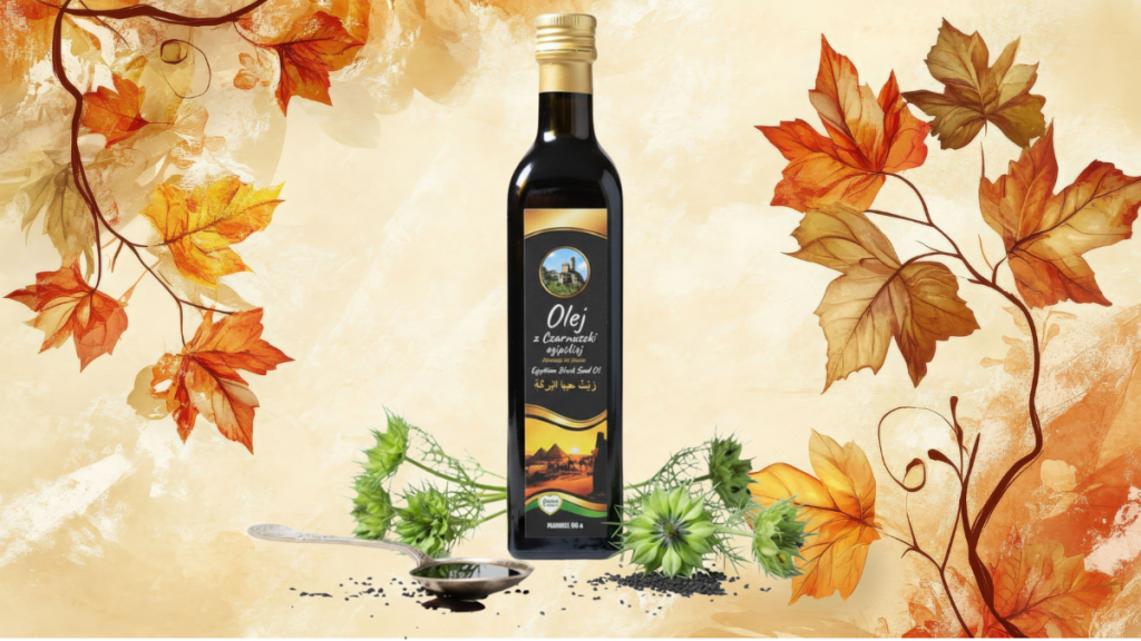 Butelka oleju z czarnuszki na tle jesiennych liści i ziół, symbolizująca naturalne wzmacnianie odporności.
